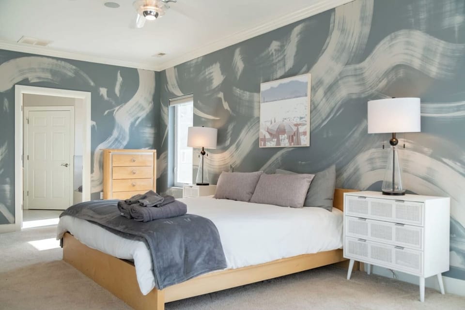2nd floor suite with king bed, twin bed, electric fireplace, and attached bathroom