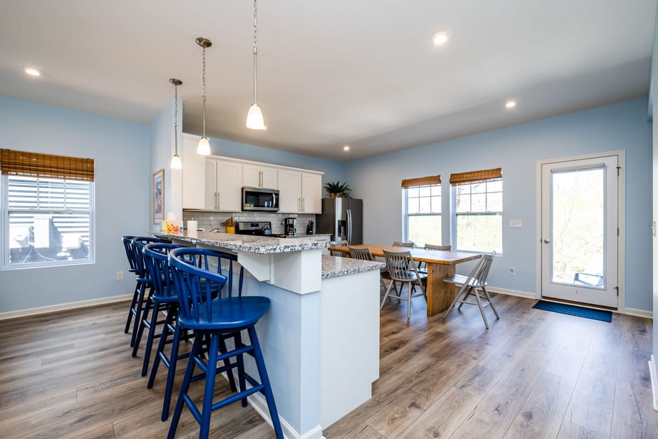 Bar height stools make a great gathering place between the living room and kitchen
