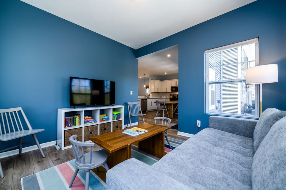 Sunroom with seating for children, books, board games, and toys