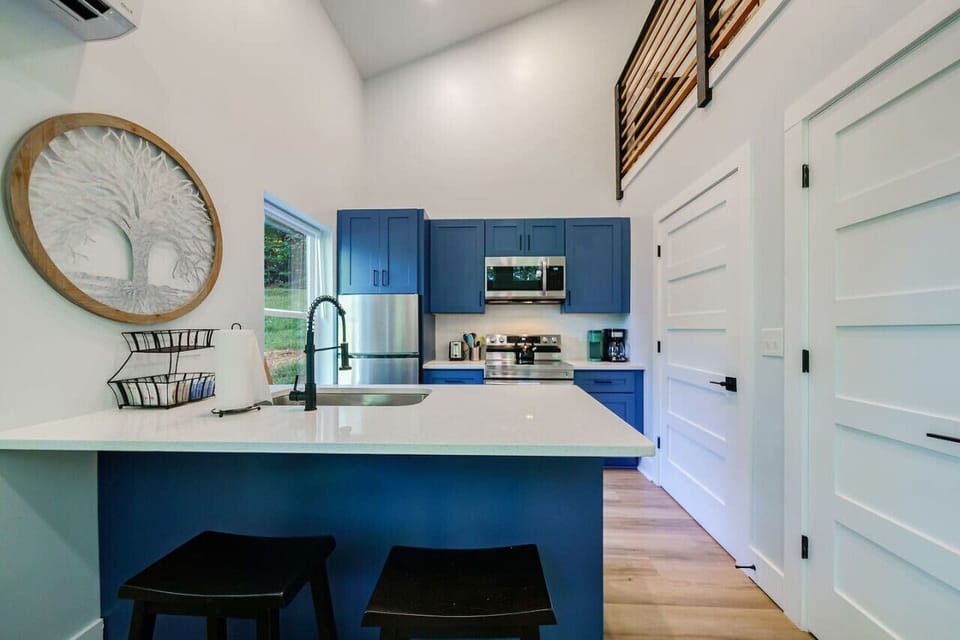 Full kitchen and door to laundry closet with clothes washer and dryer