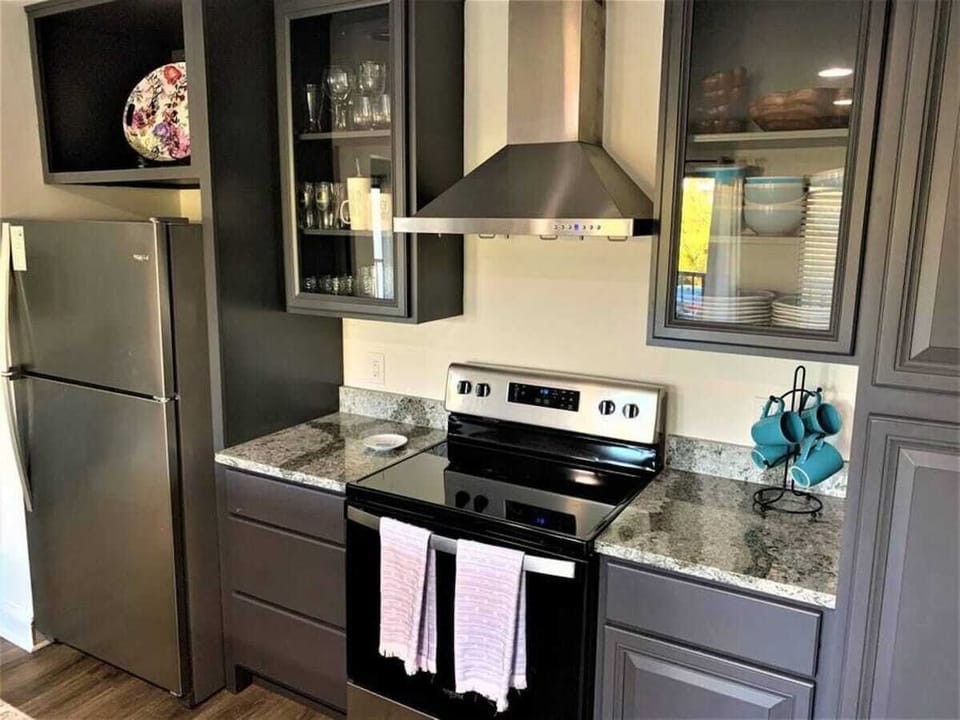 
Features sleek charcoal cabinetry and high-end stainless steel appliances.