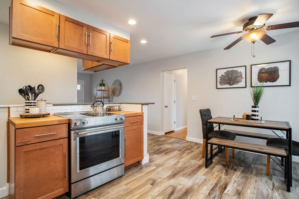 Modern stove & sleek utensils, set for sizzling home-cooked meals & memorable dining experiences.