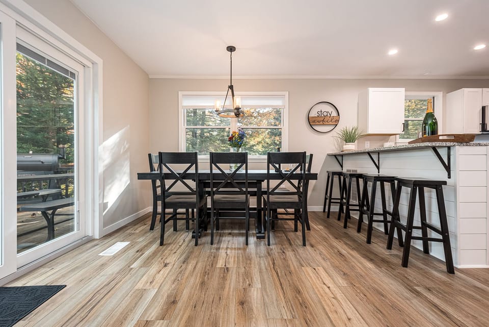 The dining room table comfortably seats 8 people plus 4 additional barstools.