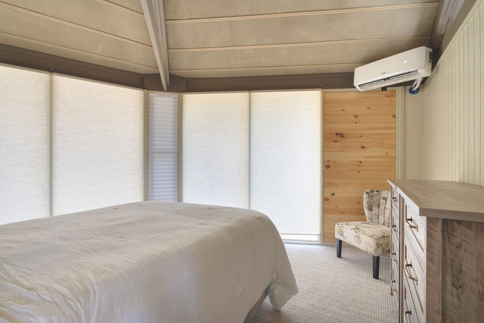 Queen bedroom with large windows. 