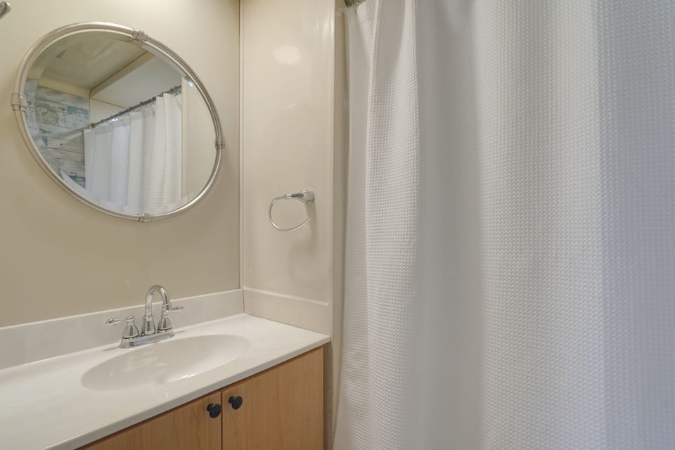 Bathroom with shower and large sink. 