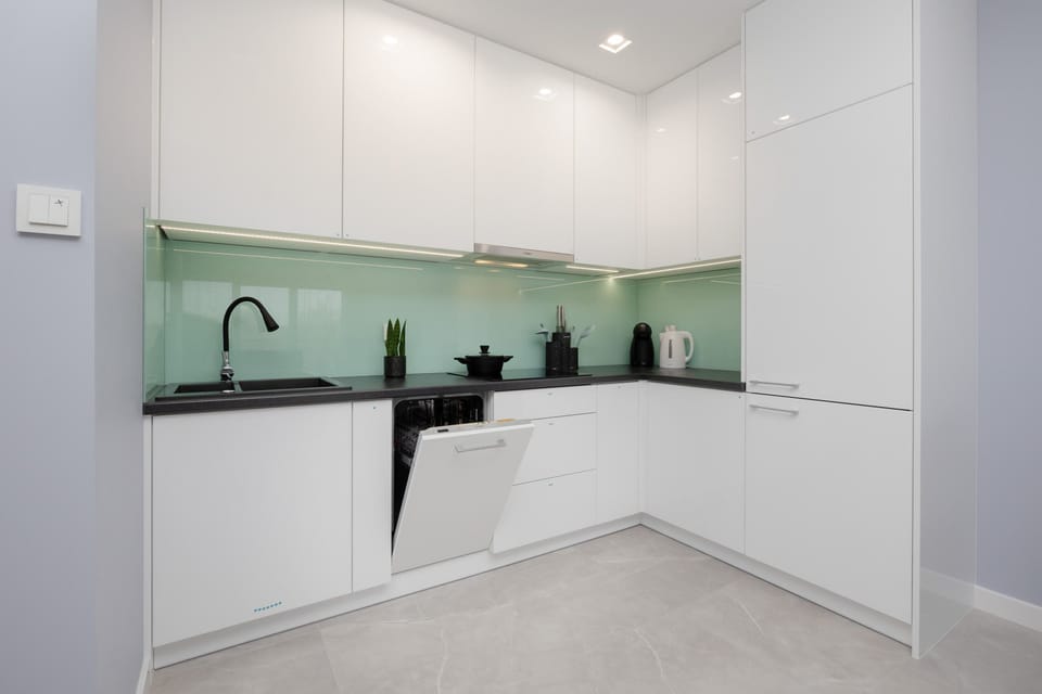 A close-up of the kitchen counter with a coffee machine, kettle, and other essential appliances for guest convenience.
