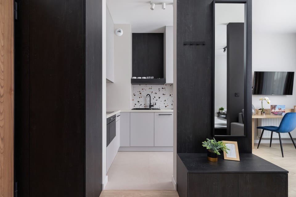 A modern hallway leading to the kitchen and living areas, emphasizing the apartment’s sleek and functional layout.
