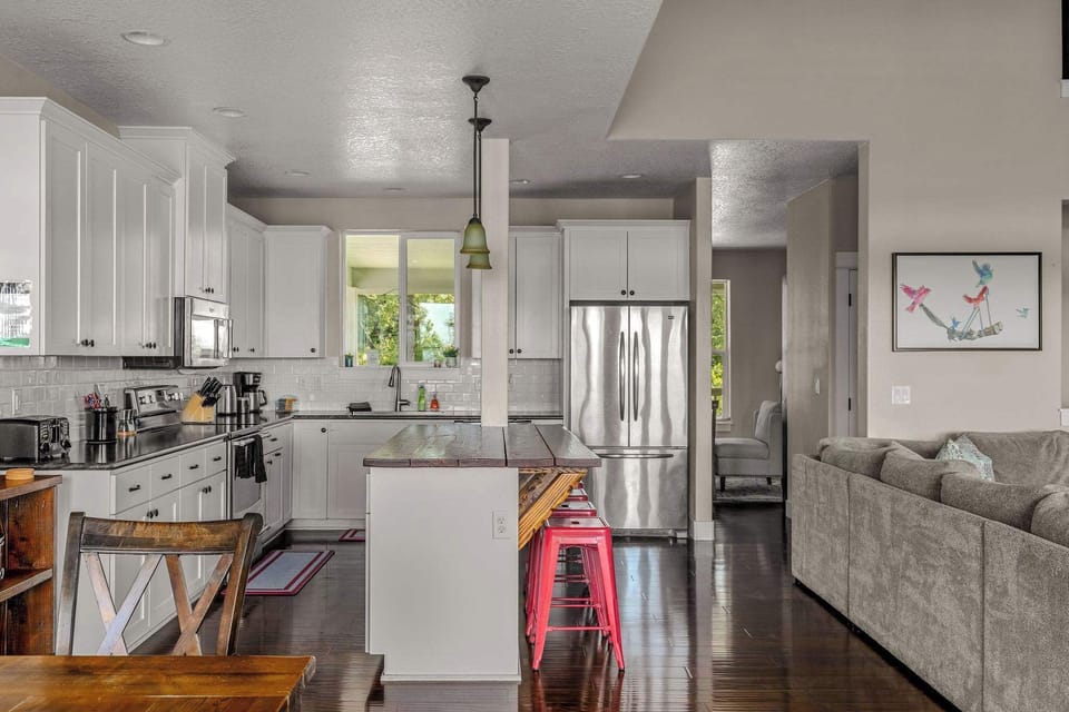 A spacious kitchen island gives everyone a place to gather for breakfast, snacks, and evening drinks.