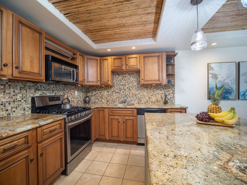 Fully equipped kitchen with custom cabinetry and granite counters.