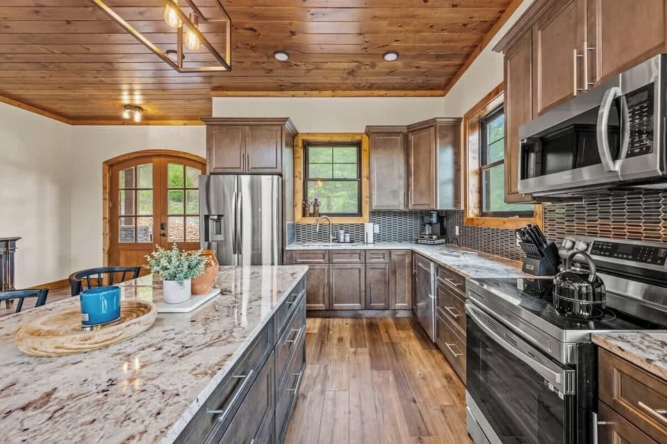 Another view of the kitchen, showcasing ample counter space and beautiful wood accents.