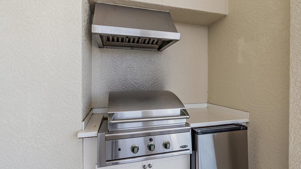 Stainless steel outdoor gas grill available for use.