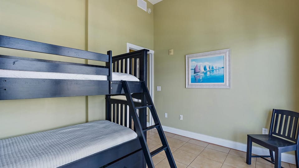 Bunk bed room with two twin beds with patio access.