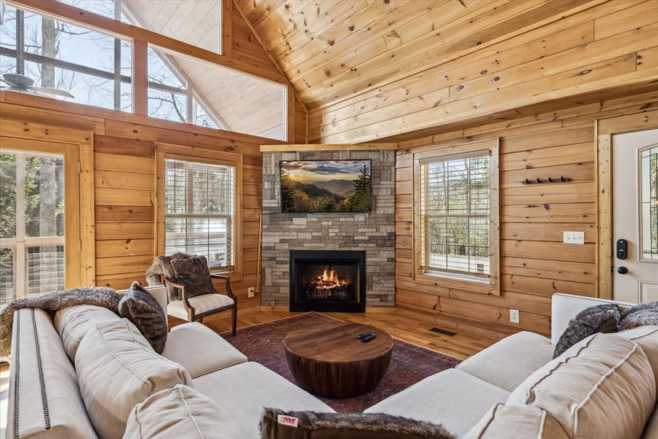 Cozy up in this spacious living room! Soaring vaulted ceilings with fireplace.