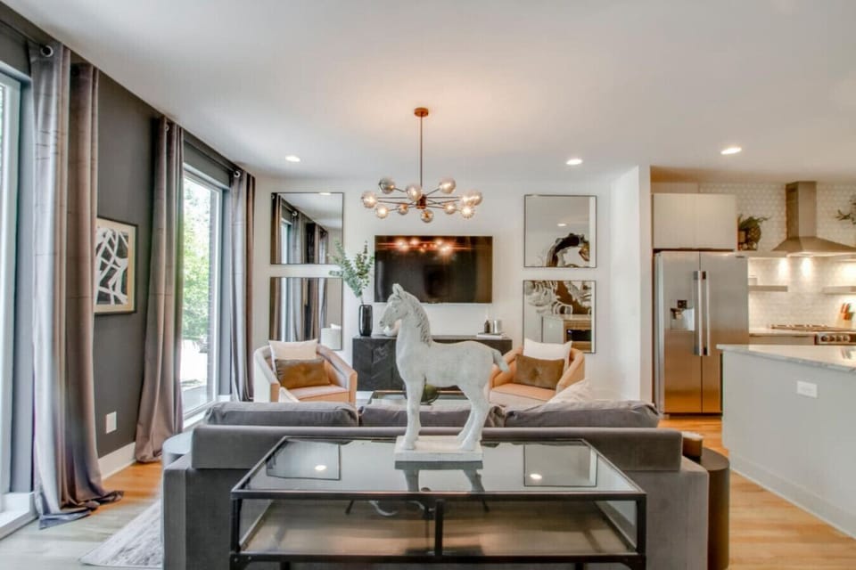 Inviting living room with a sectional sofa, chandelier, and tasteful art