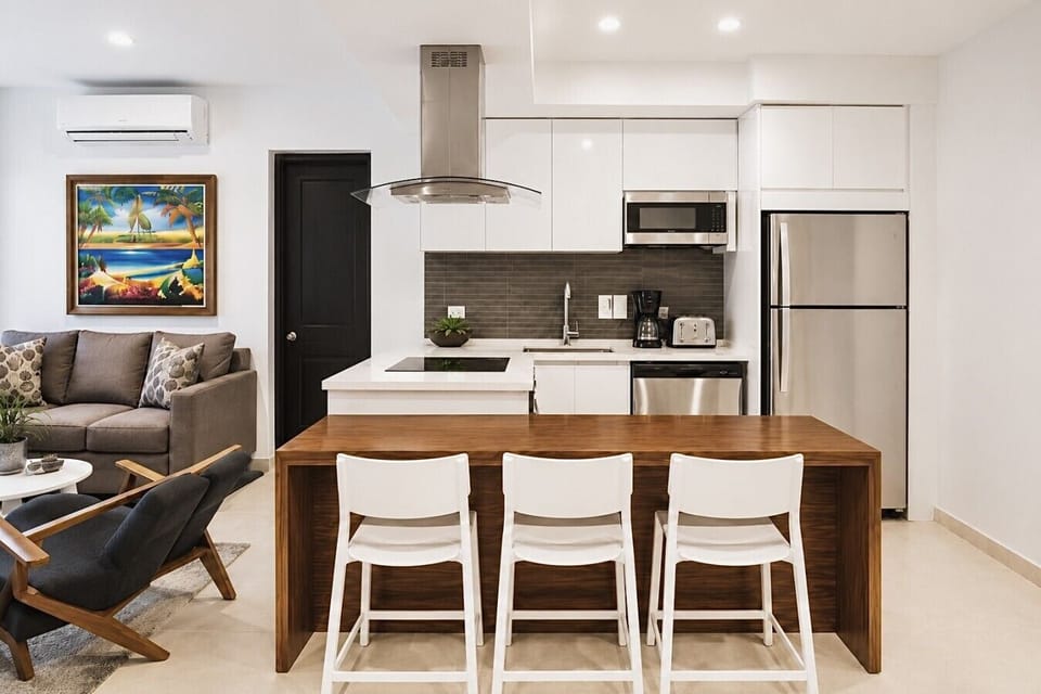 Fully equipped kitchen featuring modern appliances, cookware, essentials, and ample space for meal preparation.