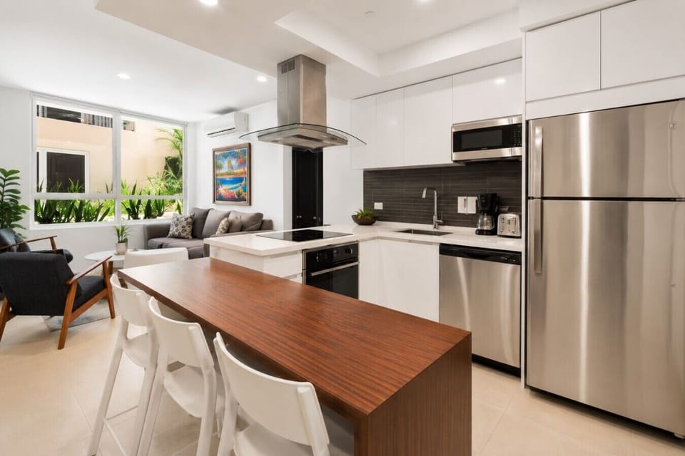 Fully equipped kitchen featuring modern appliances, cookware, essentials, and ample space for meal preparation.