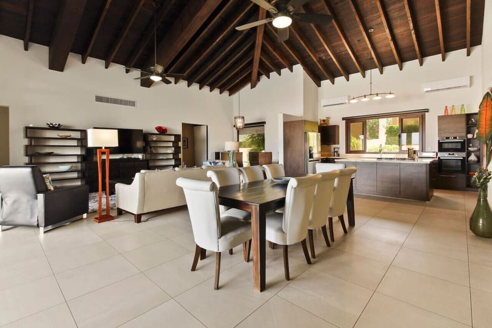 The dining room table has seating for 10 andoverlooks the fabulous pool with a full wall of accordion-style doors openingto the pool.