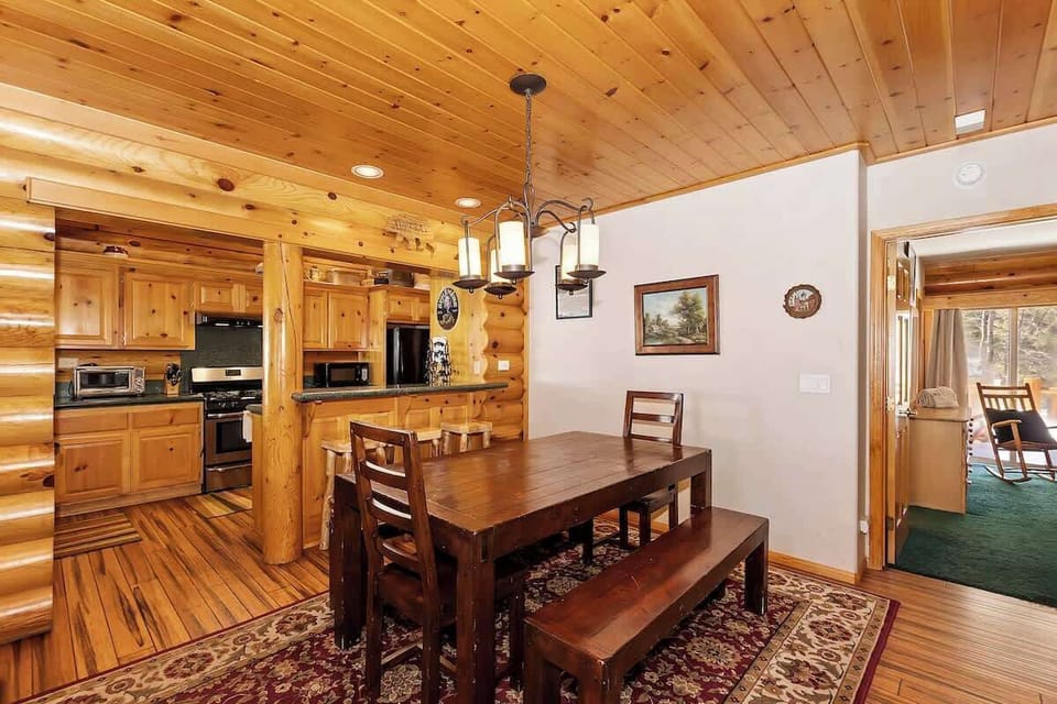 Dinning room and barstool seating at kitchen countertop. 