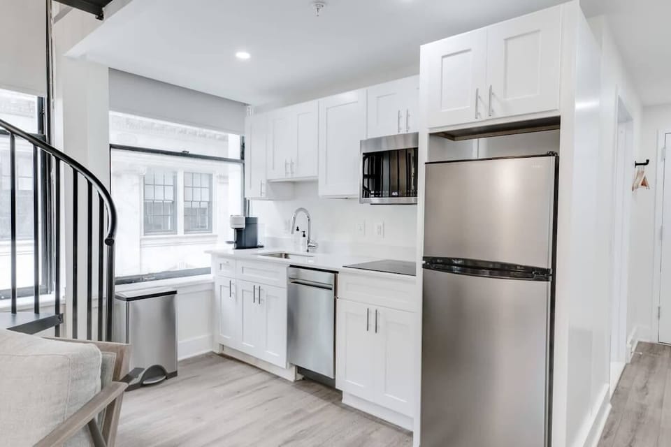 Enjoy making home-cooked meals or getting takeout in this lovely kitchen with stainless steel appliances and a full-size refrigerator