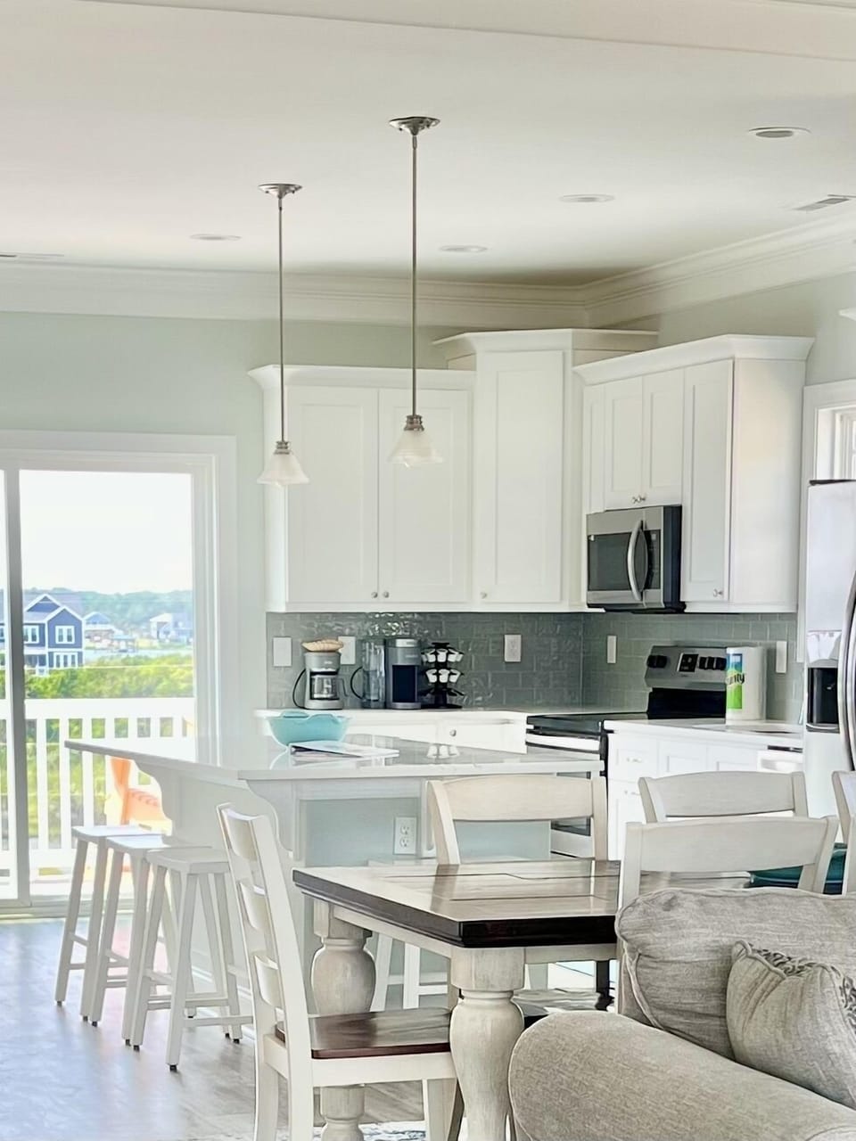The kitchen is well stocked with new dishes, glassware, pots, & pans.