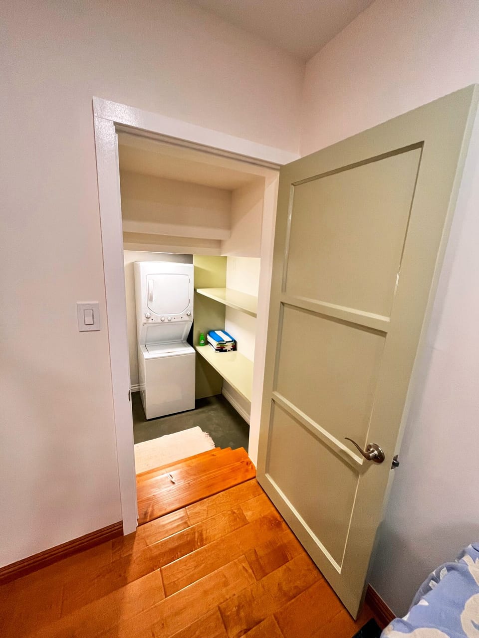 Laundry room  with stackable washer and dryer and storage