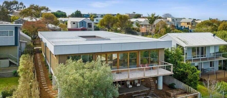 Blurring the lines between indoor and outdoor living, sliding glass doors lead to multiple decks