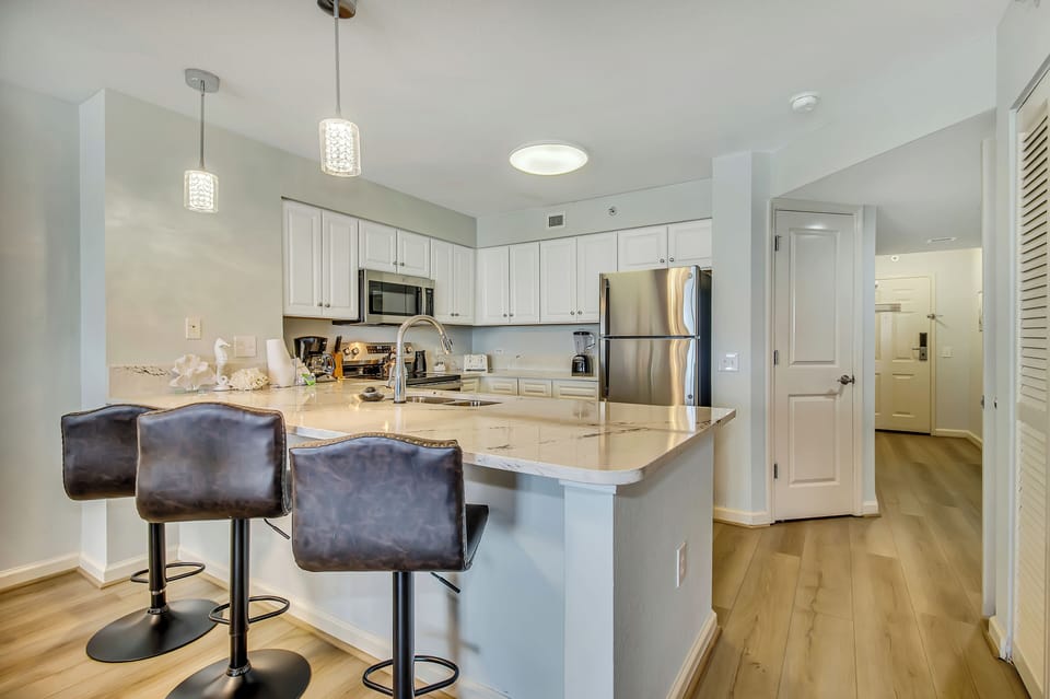 Your spacious kitchen features granite countertops, stainless steel appliances, and a breakfast bar where you can enjoy morning coffee.