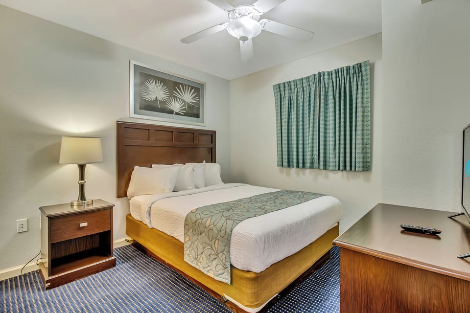 Your peaceful bedroom retreat features a comfortable king bed, soothing coastal colors, and modern amenities for the perfect night's sleep.