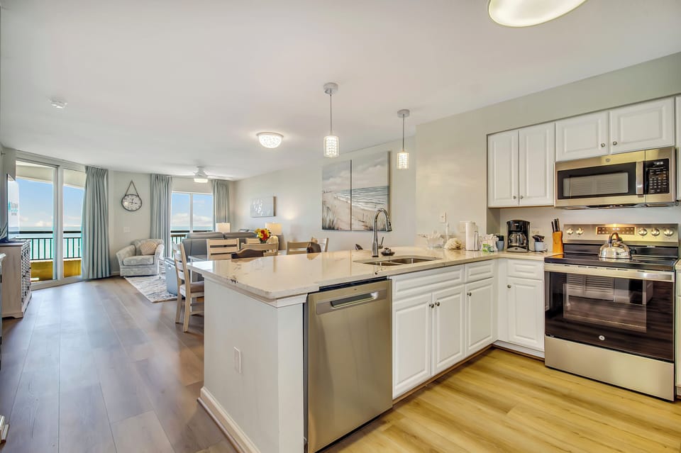 Your spacious kitchen flows seamlessly into the living area, featuring gleaming countertops and modern appliances perfect for creating memorable meals together.
