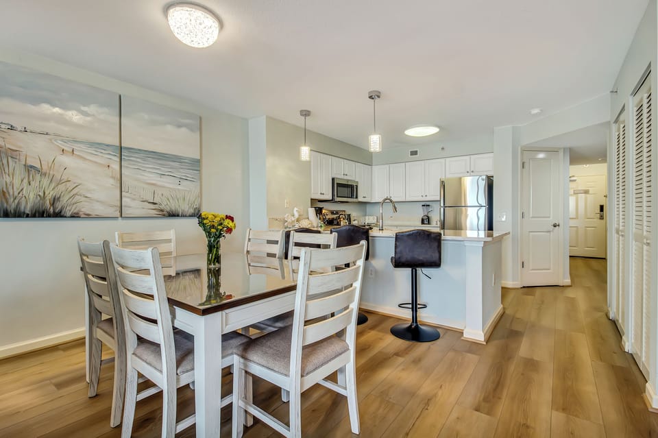 Your open-concept space flows beautifully from dining to kitchen, perfect for cooking together and sharing meals in this bright, coastal-inspired home.