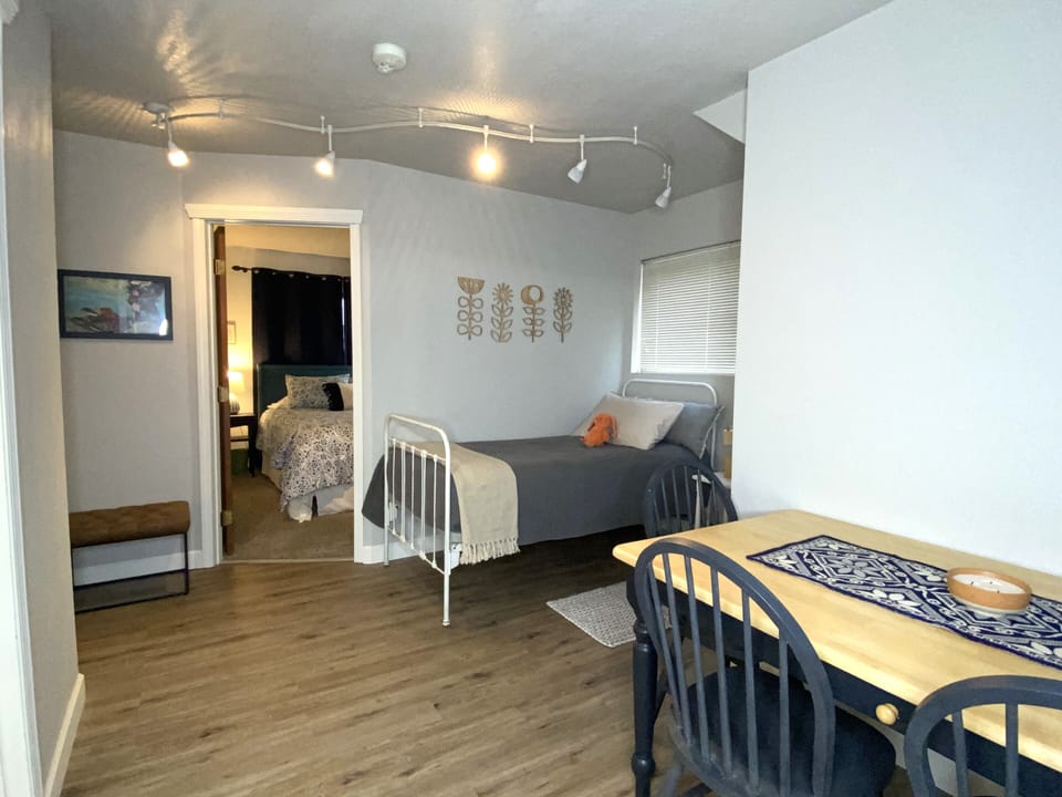Dining area and a twin bed. There is an inflatable mattress for someone.