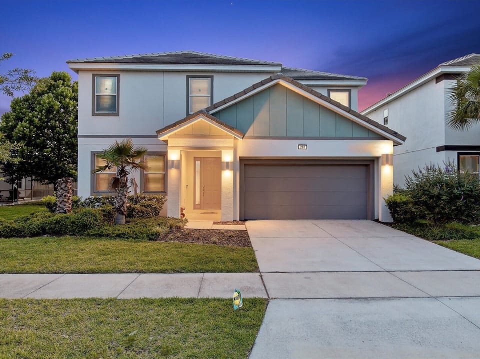 Welcoming exterior w/ tidy landscaping & easy driveway access.