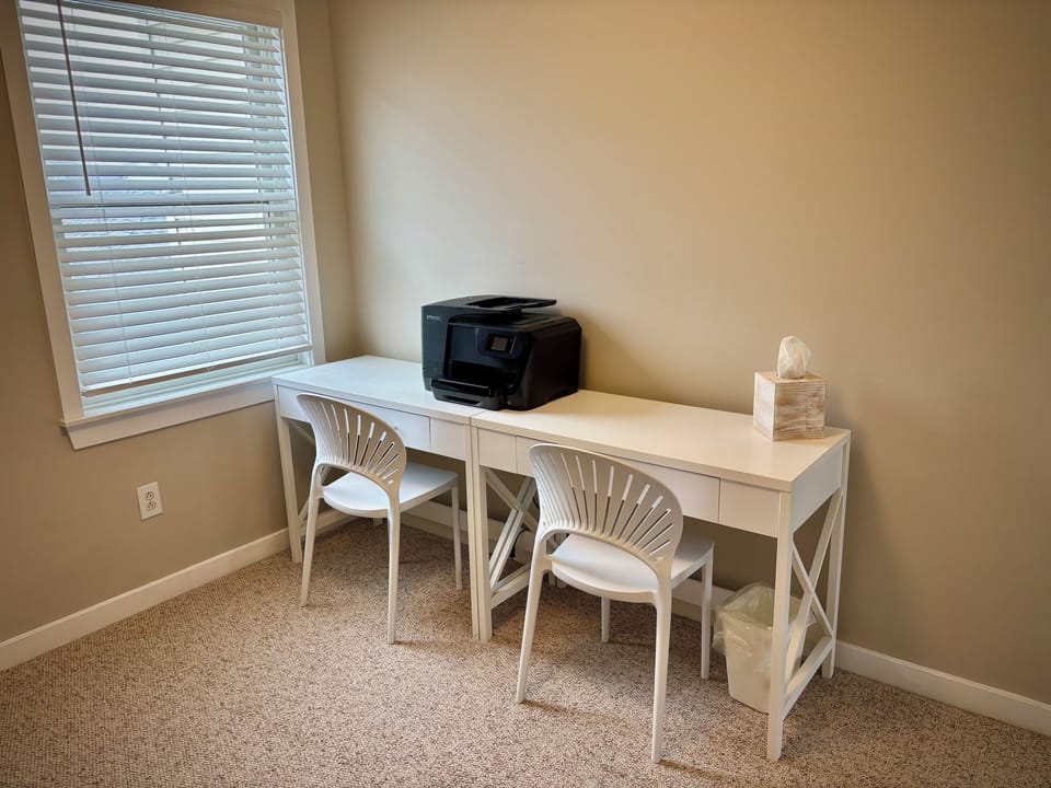 Two desks and printer in second upstairs bedroom across from bunk beds.