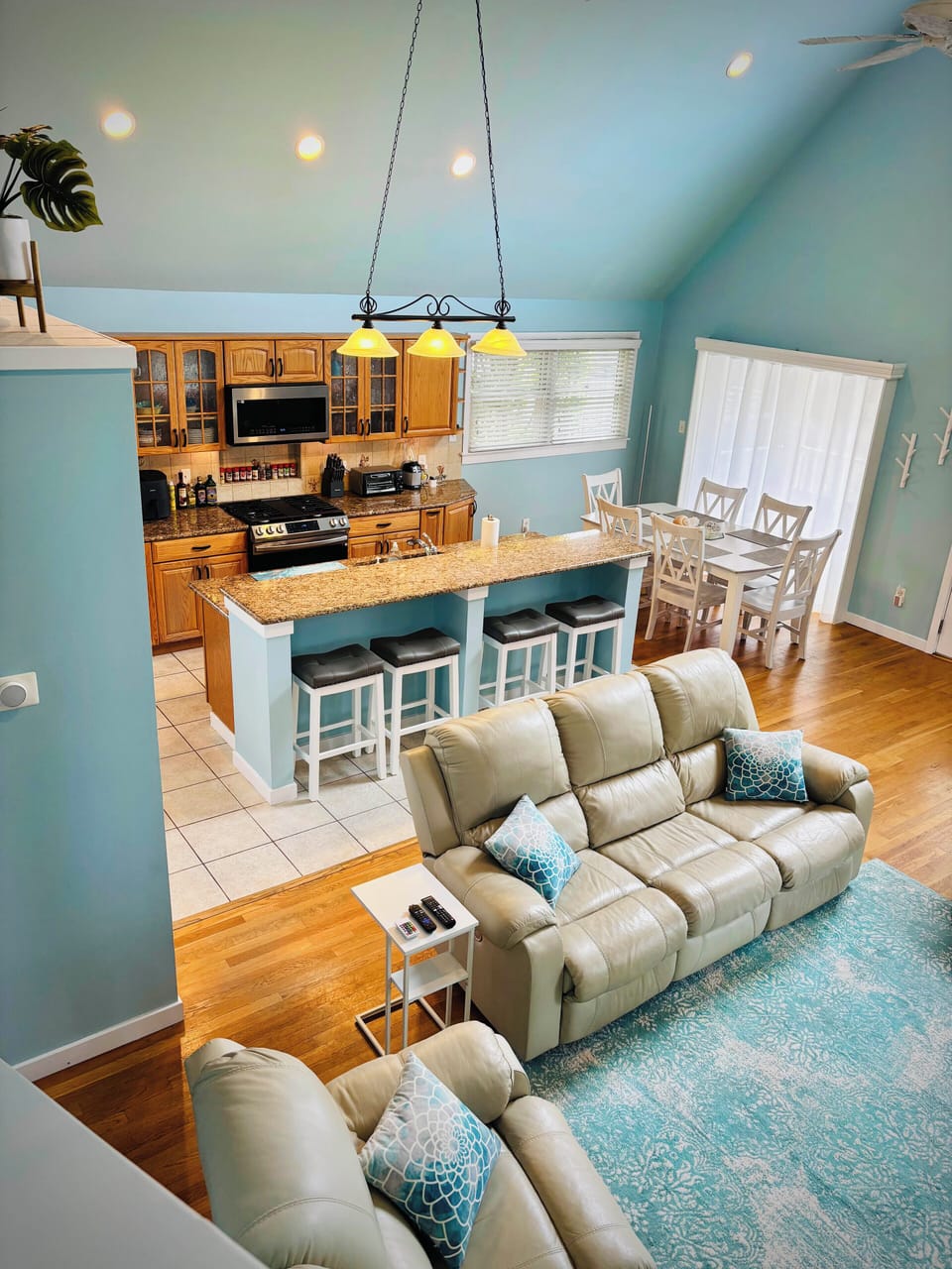 View from stairs to great room. Couches recline and have charging ports.
