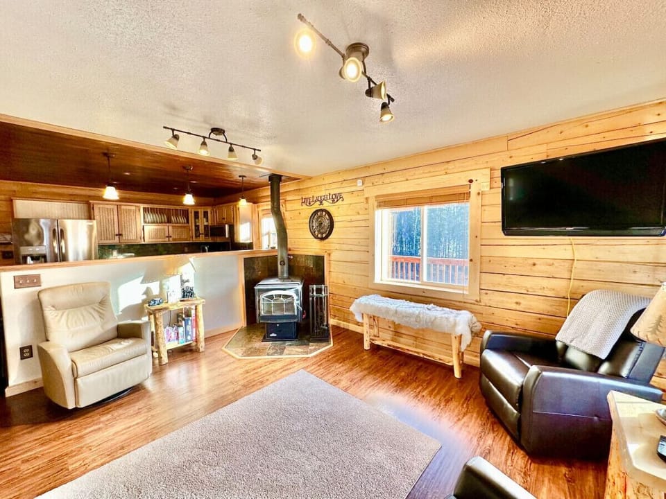 Living room view with kitchen.