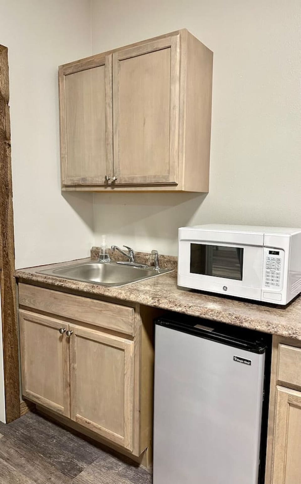 Up-close of mini fridge and microwave located in `3rd bedroom`