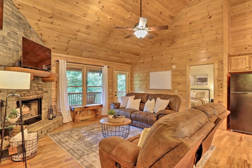 Cozy up in this family room with reclining sofas, a SMART TV, and a fireplace.