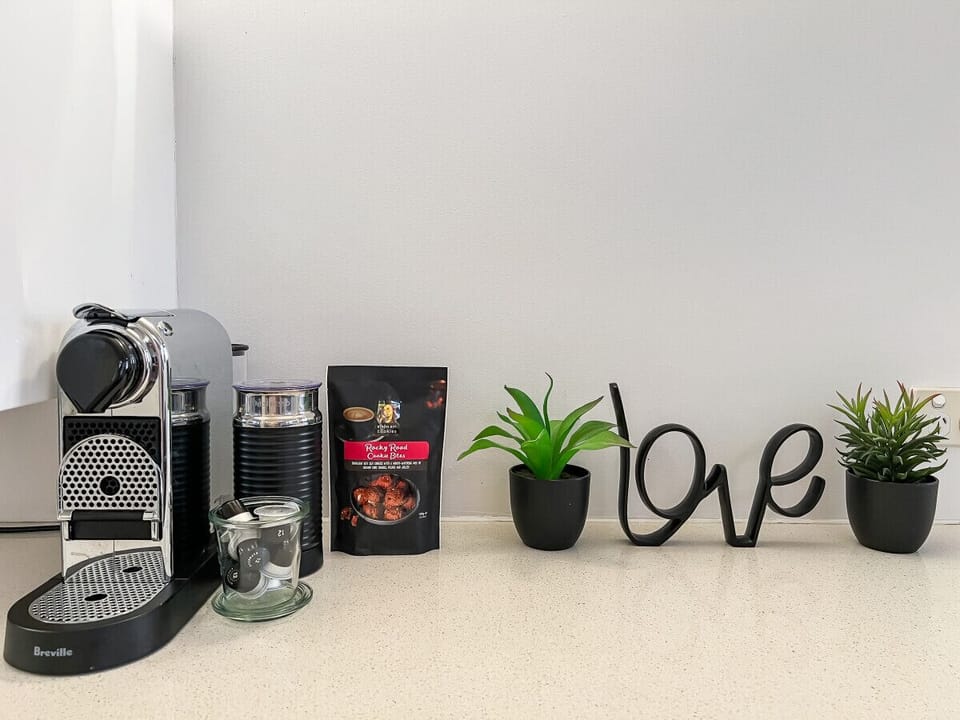 Wake up to barista-style coffee with a sleek Nespresso machine, fresh pods, and a touch of charm to brighten your morning