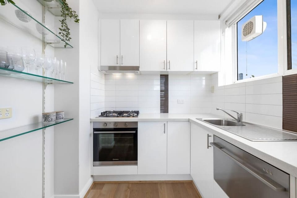 Cook up a storm in this bright, modern kitchen featuring sleek cabinetry, gas cooking, and all the essentials for a comfortable stay