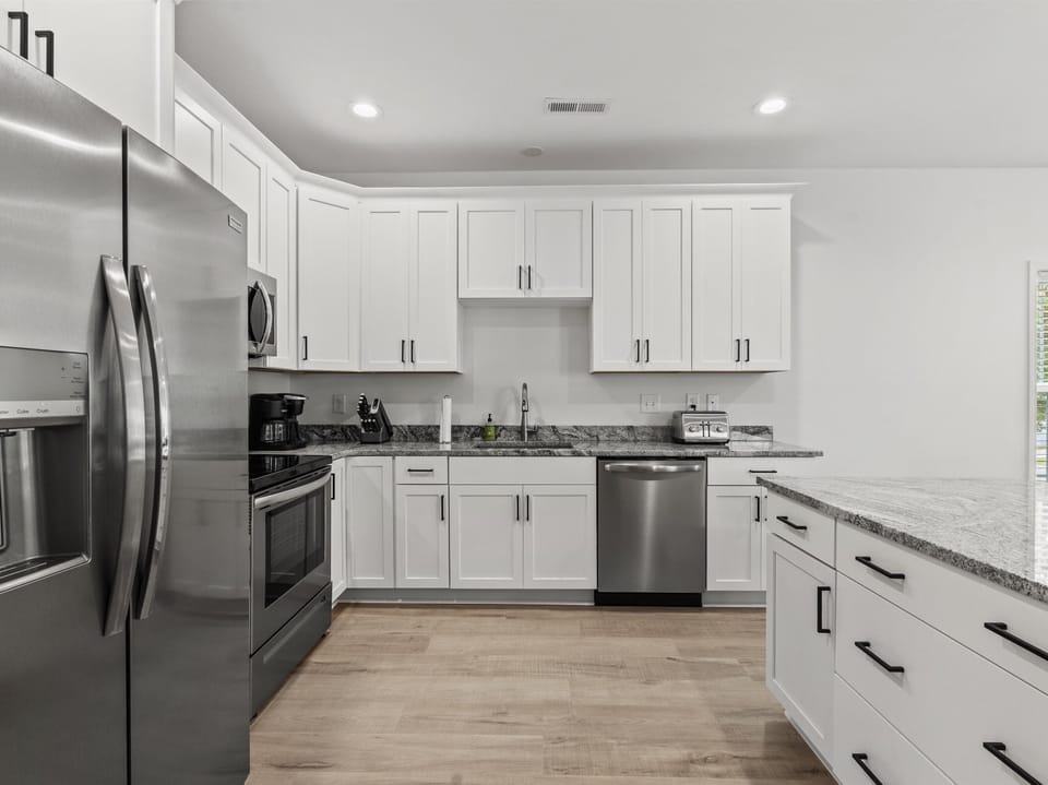 Your fully-equipped kitchen features granite counters, stainless appliances, and ample cabinet space for preparing memorable meals during your stay.