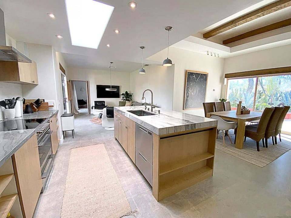 Kitchen and dining with living room in the background