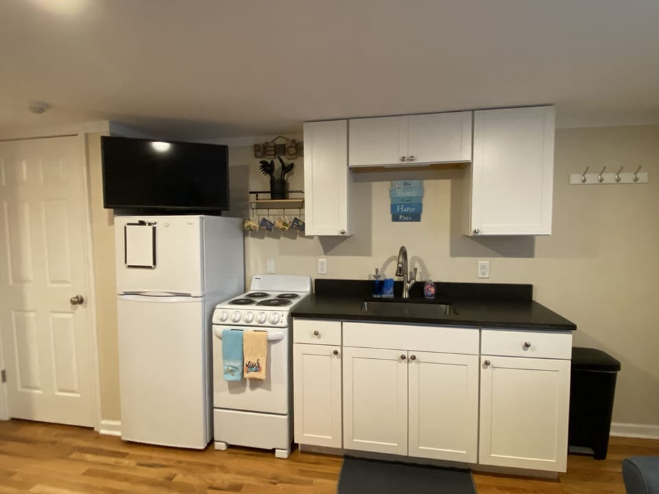 Full kitchen with refrigerator, stove, oven, and sink. 