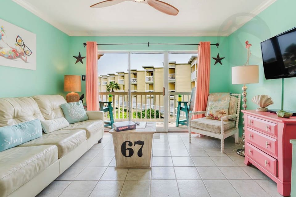 Living room has all you need including doors to the balcony