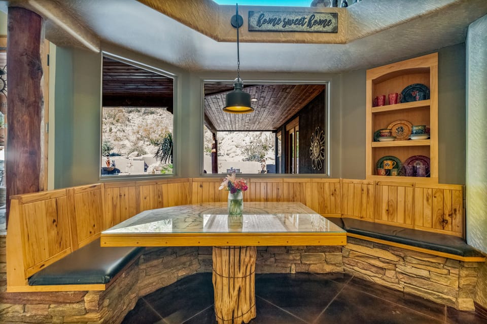 Notice the custom built-in kitchen table made from a saguaro cactus. 