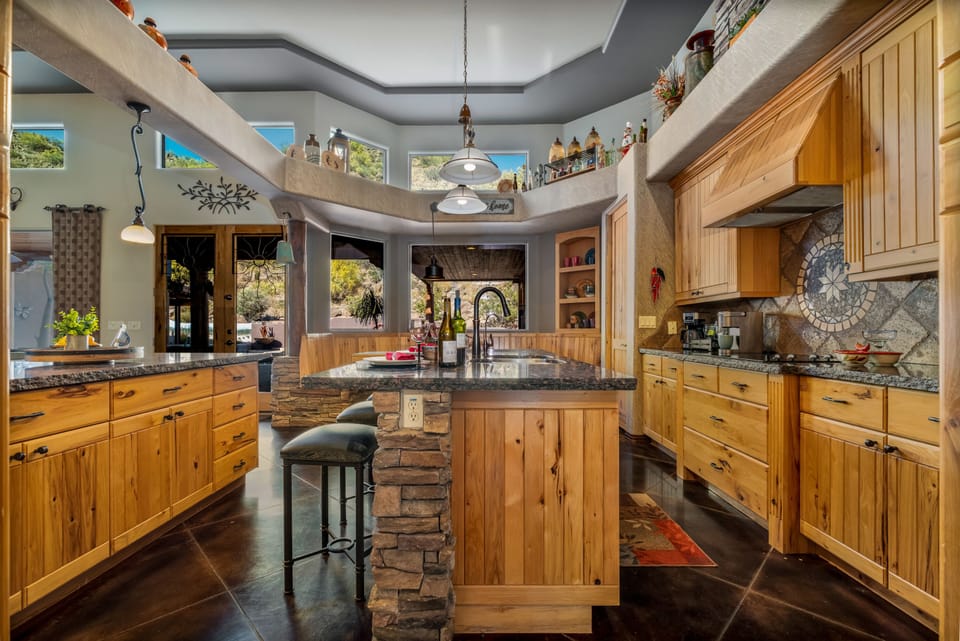 Large Kitchen with stonework, granite countertops, and solid hickory cabinets. 