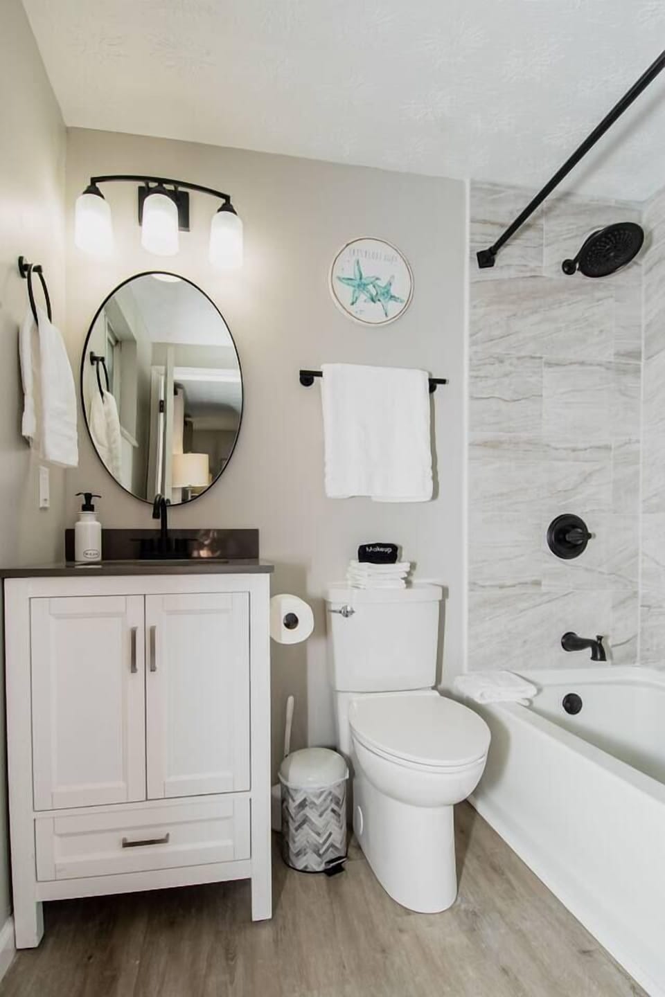 Step into the en-suite bathroom’s modern tub and shower combination for a relaxing soak.