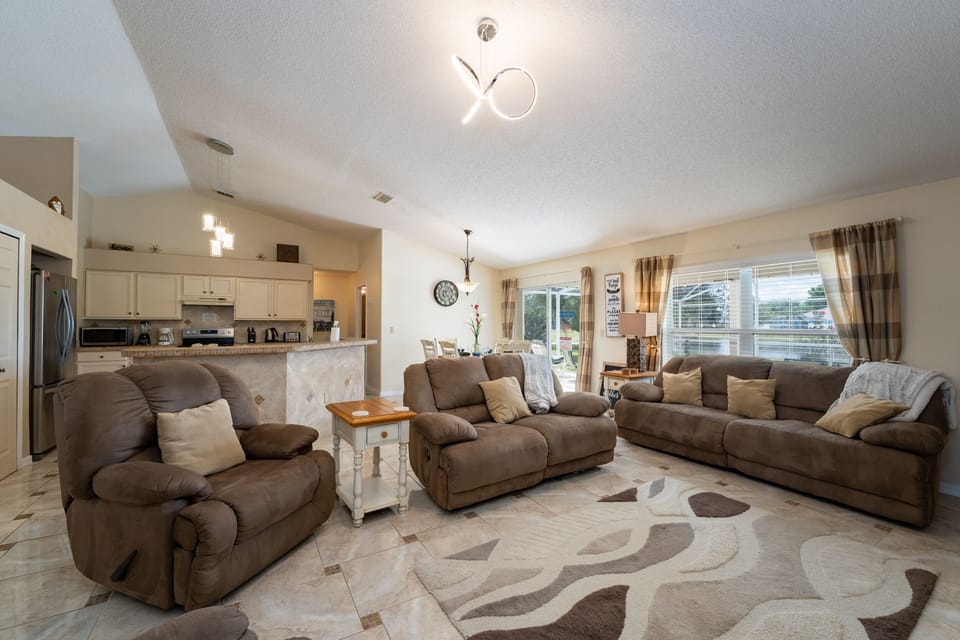 Living room showing sofa and 2 recliners