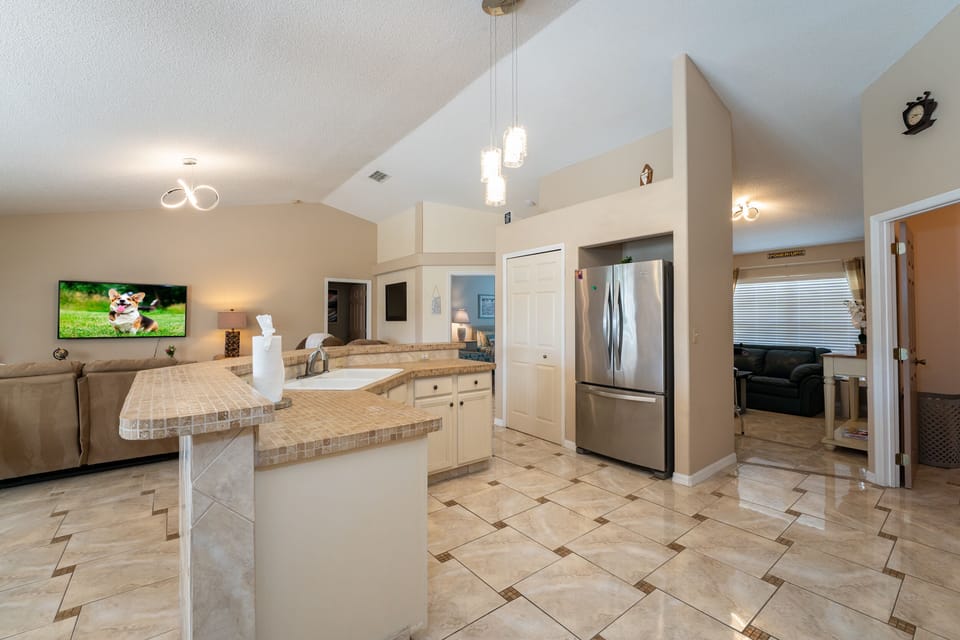 Open floor plan showing kitchen, living and family room with arcades.