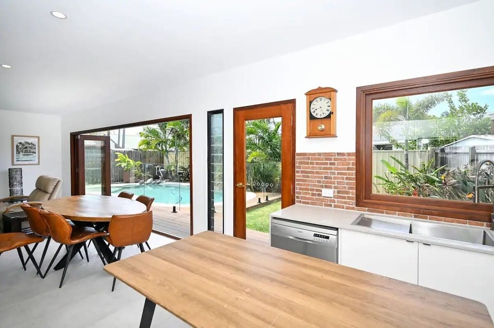 Kitchen, dining, Lounge with a view of the pool