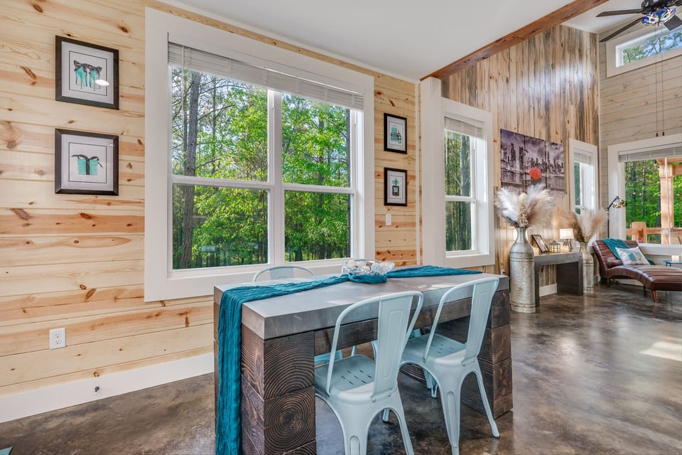 Bright dining nook with forest views and rustic modern décor